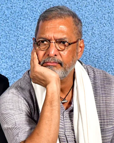 Nana Patekar in a grey kurta and glasses, resting his chin on his hand, at a Housefull 5 promotional event in 2025