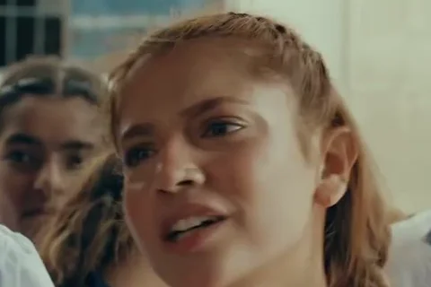 Dananeer Mobeen as Afsana Baloch in a school uniform, with other girls behind her
