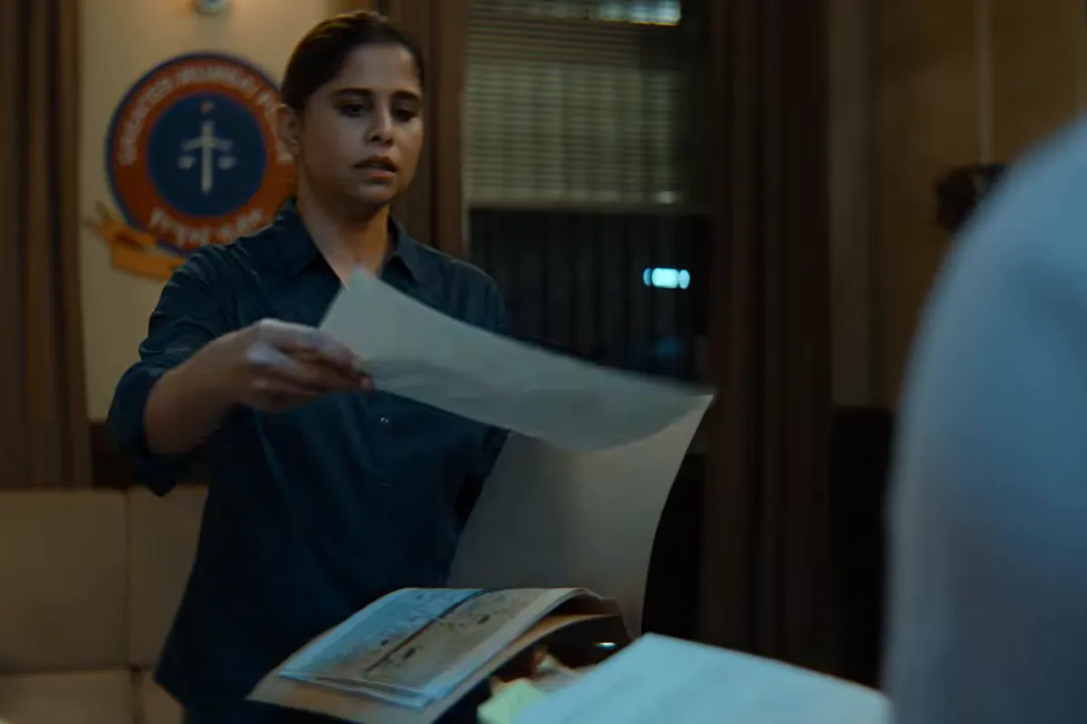 Sai Tamhankar as Inspector Sumati Bhalerao, holding papers in a police office
